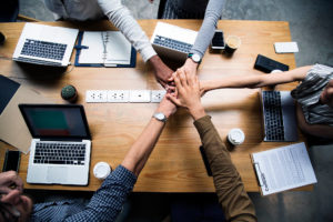 team-of-business-people-stacking-hands